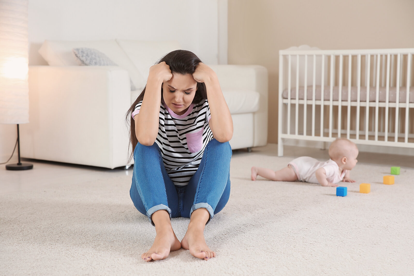 Mother in early postpartum experiencing low mood and exhaustion